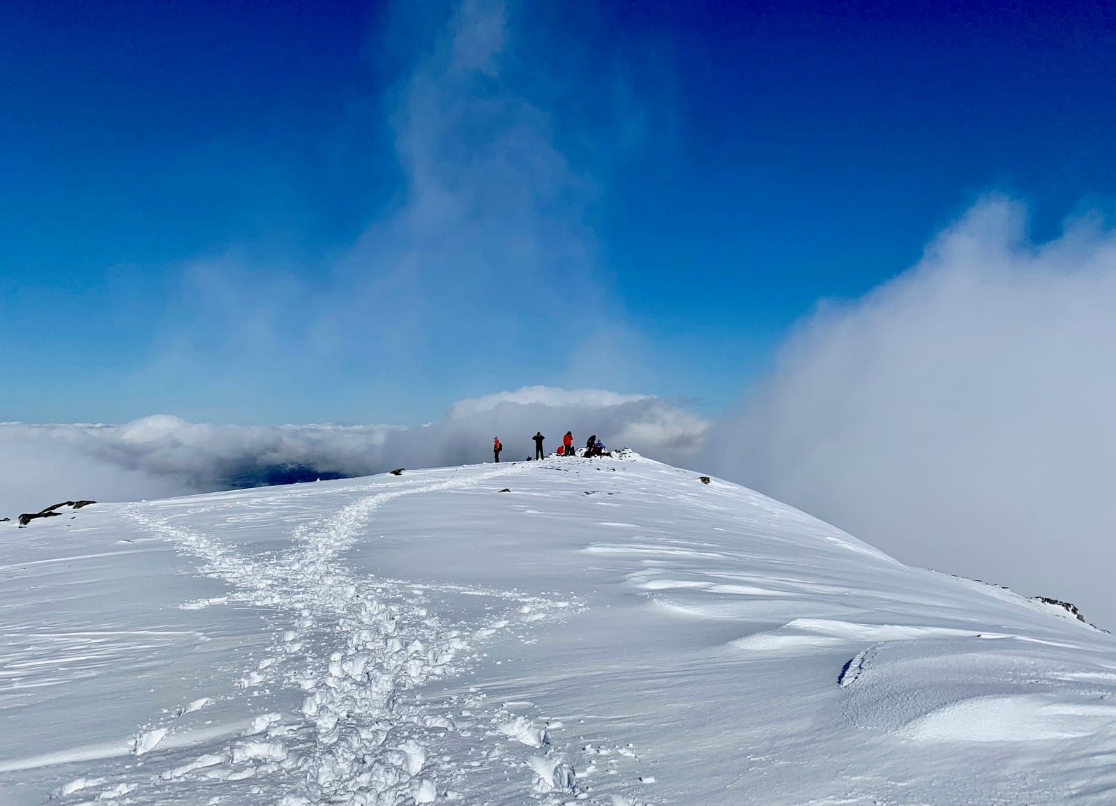 Blue sky and towering cloud above the summit of Carn Gorm as the early mist blows away