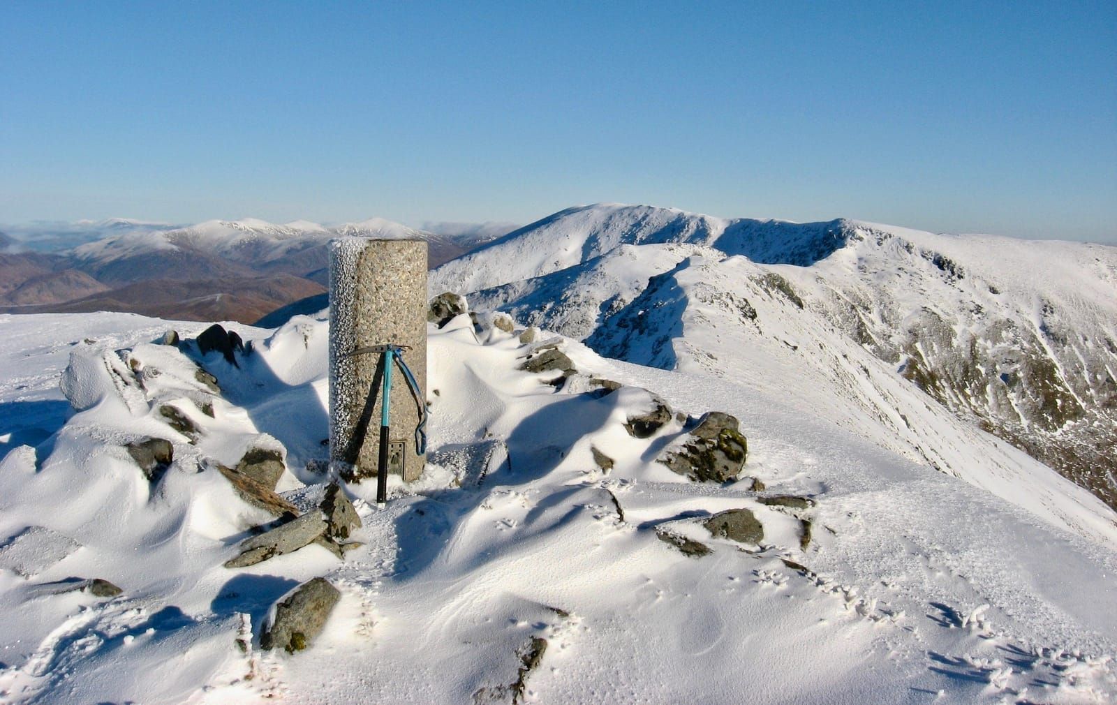 Looking back along a snowy mountain ridge on a winter Corbett walk